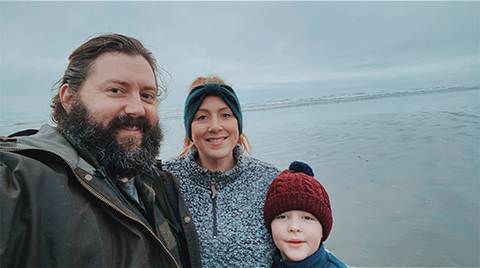 Morgan and her family standing on an overcast beach